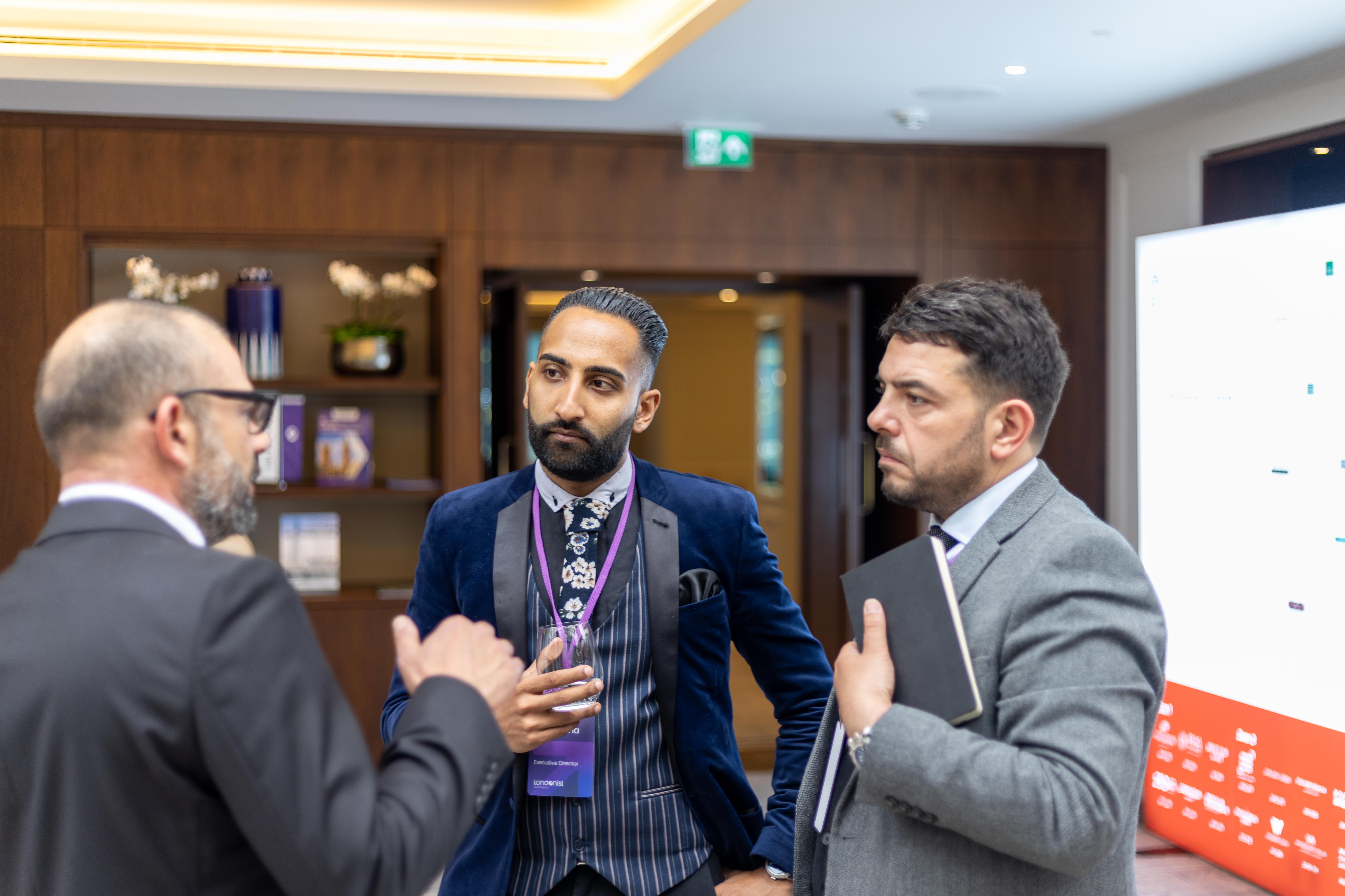 Two members of the Londonist Investment team engaged in a dynamic interaction with a distinguished member from the Berkeley Group